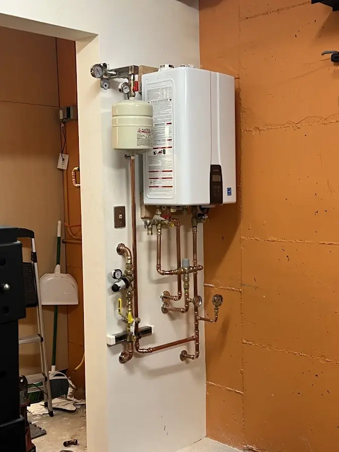 Plumbing technician inspecting water heater connections in Lubbock